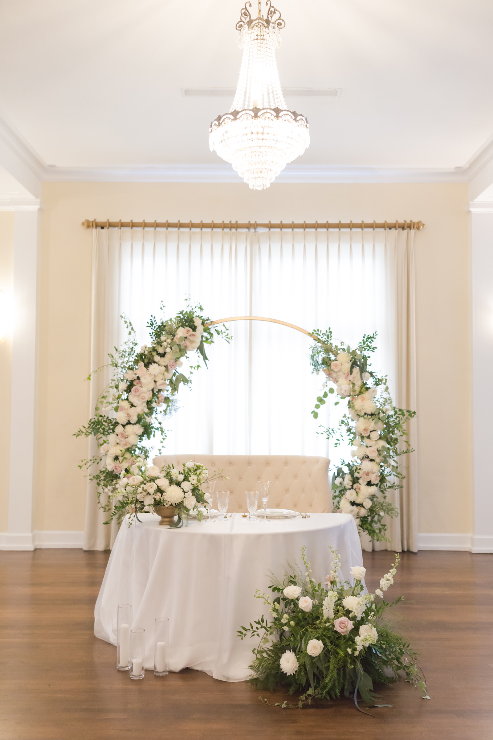 Southern Charm classic and timeless wedding reception decor, circular arch with lush white and blush pink florals, eucalyptus and greenery arrangements, sweetheart table with white linens, ivory loveseat | Tampa Bay wedding planner Elegant Affairs by Design | Kate Ryan Event Rentals