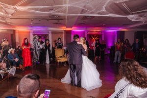 Halloween Bride and Groom First Dance Photo, Purple Uplighting, Cobwebs on Ceiling | Tampa Bay Wedding Planner UNIQUE Weddings and Events