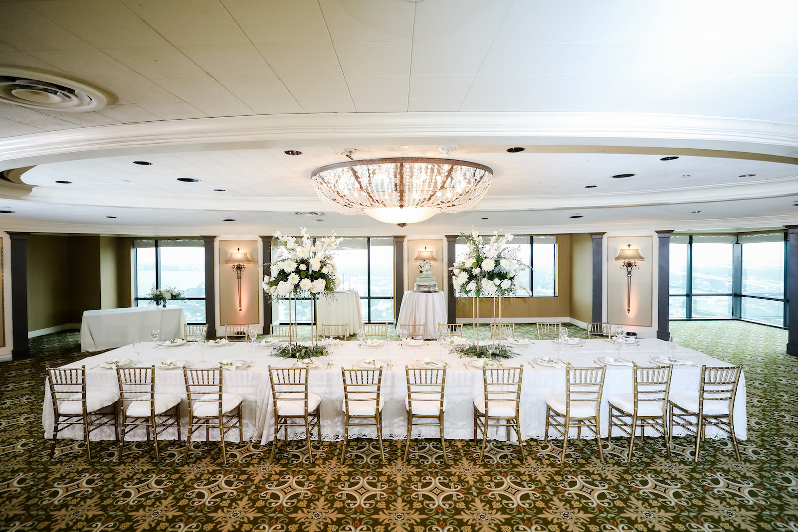 Classic Ballroom Wedding Reception Decor, Long Feasting Table with White Linens, Gold Chiavari Chairs, Tall White and Greenery Lush Floral Centerpieces | Wedding Venue The Tampa Club | Wedding Planner Elegant Affairs by Design | Wedding Photographer Lifelong Photography Studio | Wedding Lighting Breezin' Entertainment | Wedding Linens Over the Top Rental Linens | Styled Shoot | Wedding Rentals Outside the Box Event Rentals