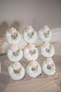 Unique Wedding Desserts, Blue and White Swirl Donuts with Pink Sugar Flowers Hanging on Acrylic Wall | Tampa Bay Wedding Photographer Carrie Wildes | Wedding Dessert Sweetly Dipped Confections | Clearwater Beach Wedding Planner Coastal Coordinating