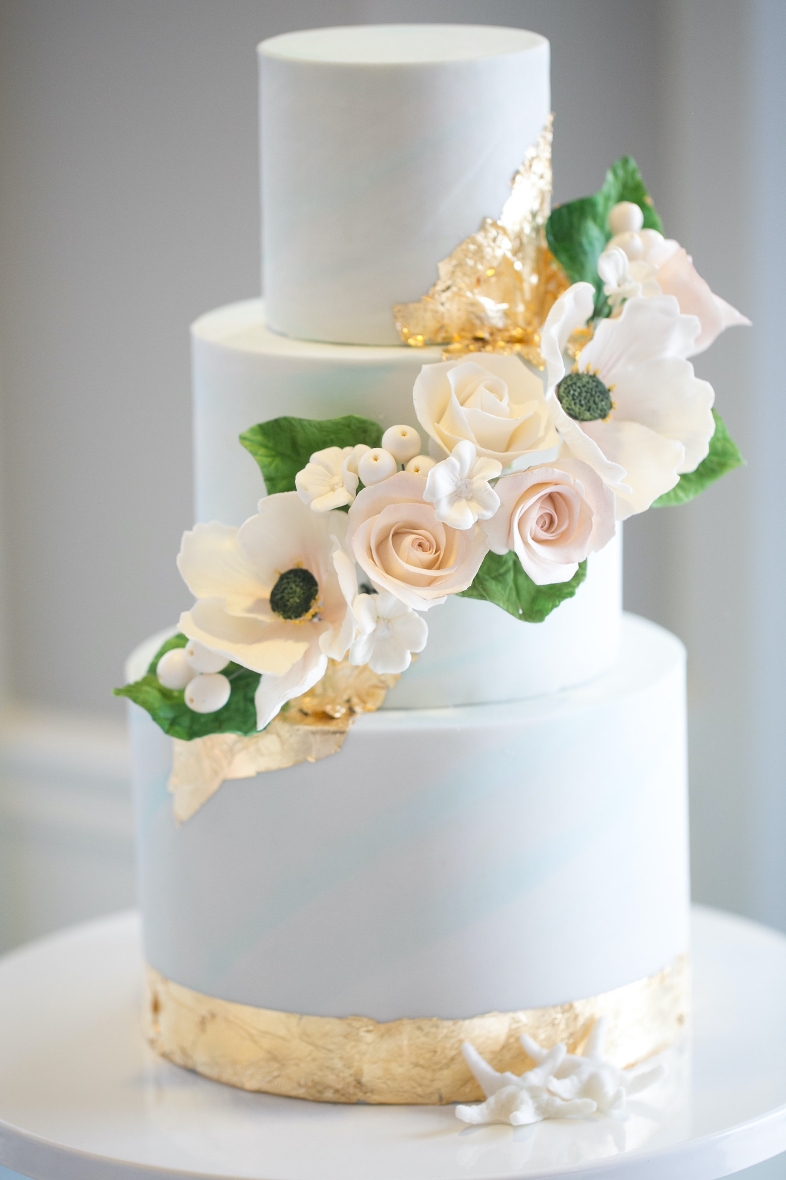 Elegant Modern Three Tier Blue and Gold Foil Wedding Cake with White Flowers | Tampa Bay Wedding Photographer Carrie Wildes | Tampa Bay Cake Company | Wedding Rentals Outside the Box | Wedding Planner Coastal Coordinating