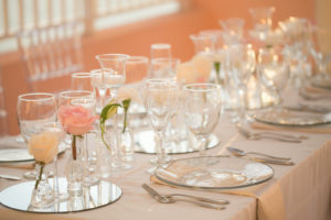 Elegant Modern Wedding Reception Decor, Long Tables with Clear Chargers, Round Mirror Trays with One Pink and White Rose Stem Flowers | Tampa Bay Wedding Photographer Carrie Wildes | Wedding Planner Coastal Coordinating | Clearwater Beach Wedding Rentals Outside the Box