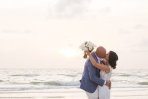 Clearwater bride and groom intimate kiss during sunset on beach