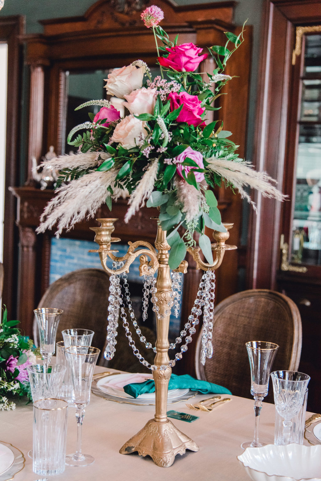 Gold Candelabra with Crystals Hanging, Jewel Toned Blush Pnk, Fuschia, Purple Roses, Greenery and Feathers Flower Centerpiece | Tampa Bay Wedding Planner EventFull Weddings | Kate Ryan Event Rentals