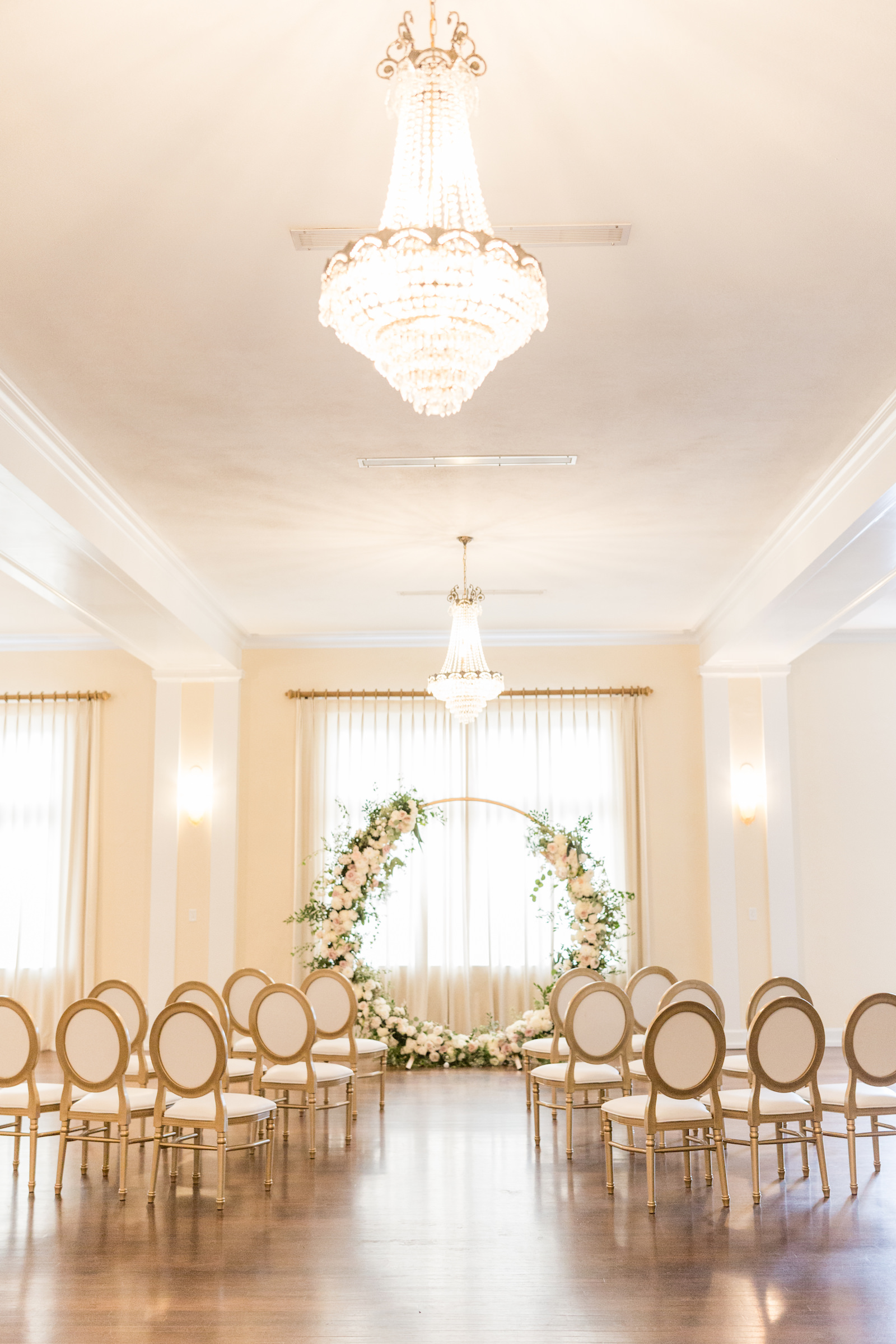 Southern charm classic wedding ceremony decor, circular arch with white lush floral bouquets, crystal chandeliers | Tampa Bay wedding planner and design Elegant Affairs by Design | Kate Ryan Event Rentals