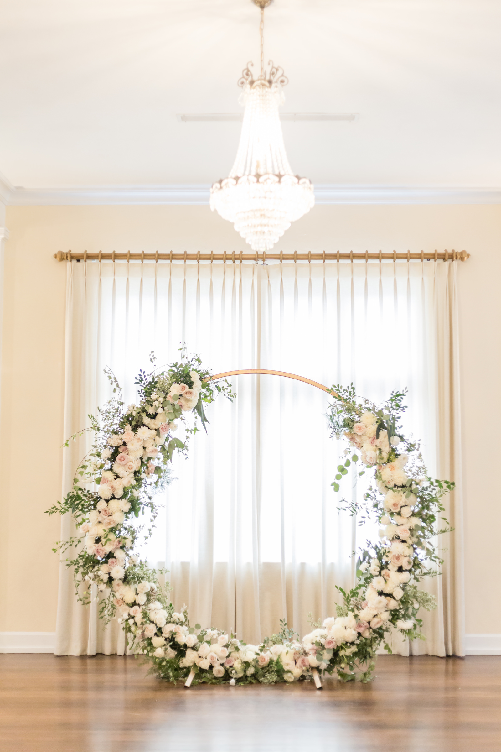Classic and timeless lush white, blush pink roses floral arrangement on circular arch, eucalyptus and greenery | Tampa Bay wedding planner and designer Elegant Affairs by Design | Kate Ryan Event Rentals