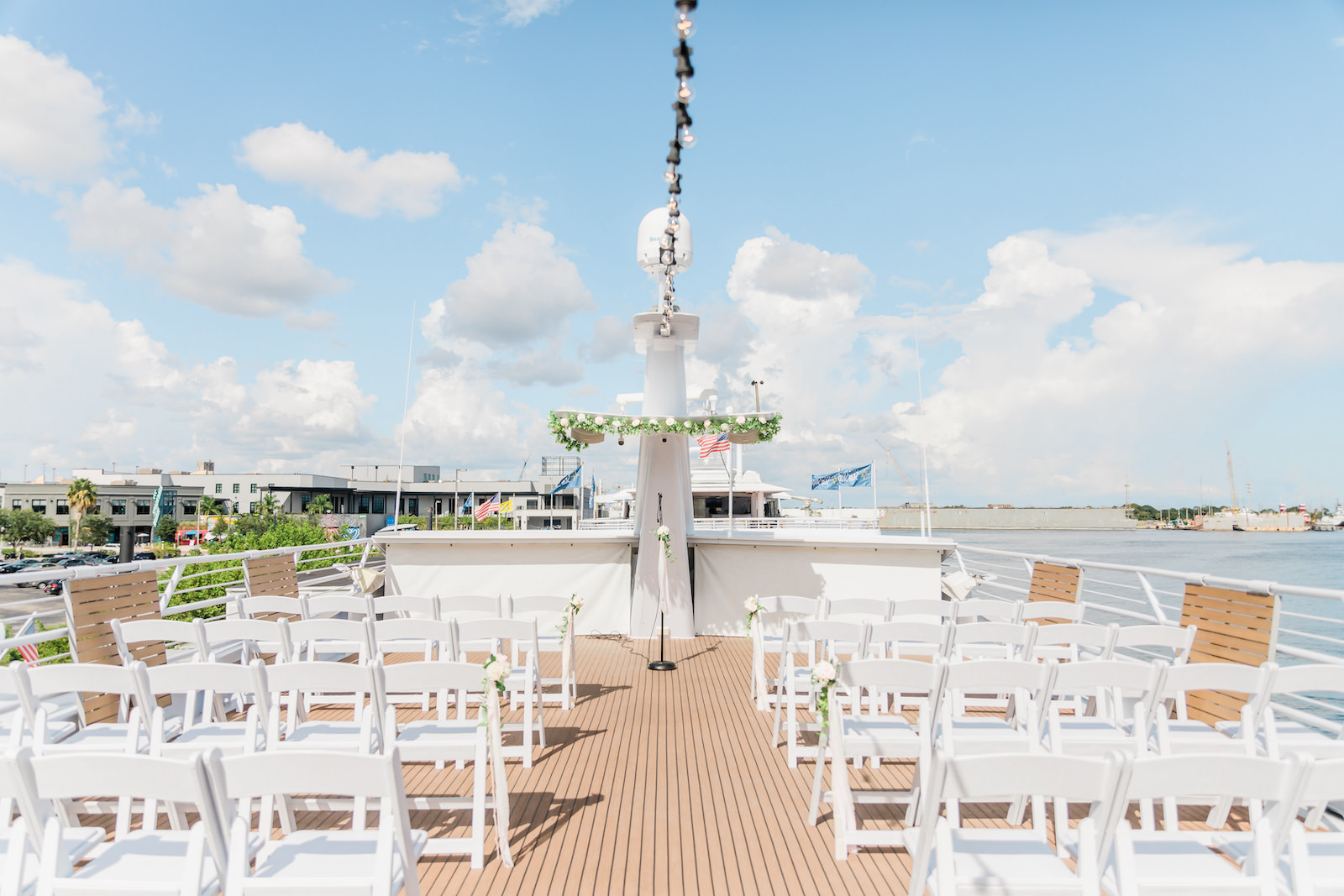Tampa COVID Wedding at Yacht Starship Venue | Waterfront Wedding Ceremony Ship Boat Deck with White Folding Garden Chairs and Greenery Garland