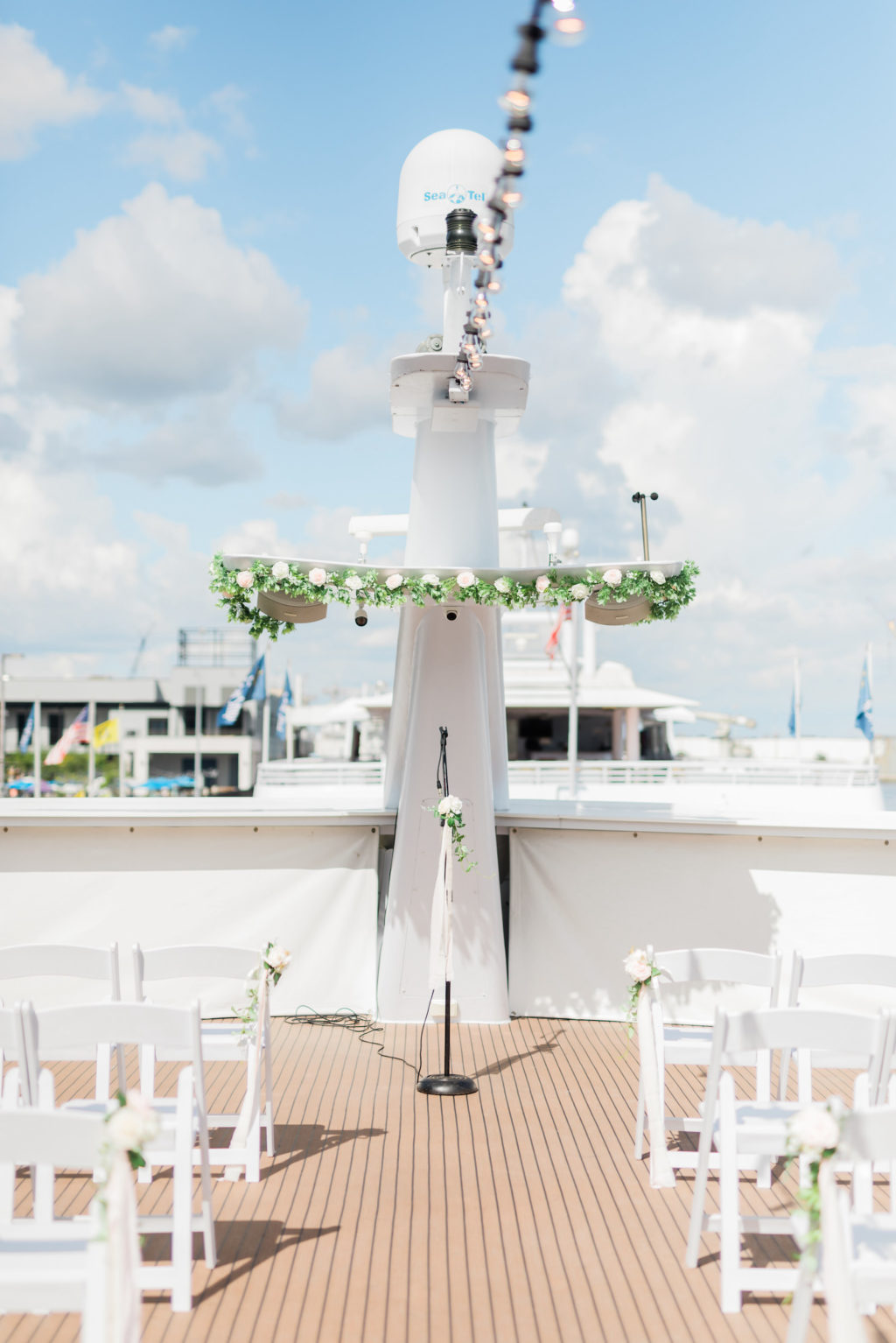 Tampa COVID Wedding at Yacht Starship Venue | Waterfront Wedding Ceremony Ship Boat Deck with White Folding Garden Chairs and Greenery Garland