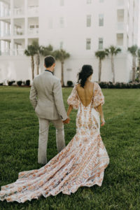 Outdoor Bride and Groom Portrait | Boho Gold Bronze Embroidered Overlay Wedding Dress Bridal Gown with Illusion Sleeves and Train | Groom in Grey Khaki Linen Suit | Amber McWhorter Photography