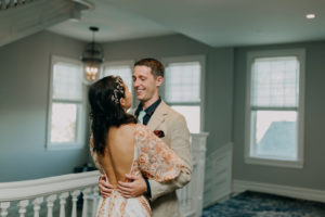 Bride and Groom First Look | Boho Gold Bronze Embroidered Overlay Wedding Dress Bridal Gown with Illusion Sleeves and Train | Amber McWhorter Photography