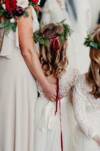 Tampa Christmas Wedding Flower Girls wearing Ivory Lace Dresses and Winter Greenery Halos with Red Velvet Ribbon