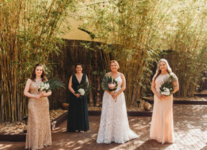 Modern Tropical Inspired Florida Bridal Party in Bamboo Garden, Bridesmaids in Long Mixed Style Dresses, Dark Green, Gold Sequined and Light Pink, Bride Wearing Blush By Hayley Paige Ivory Delta Gown, Holding DIY King Protea Monstera Leaf Bouquets | Unique Tampa Bay Wedding Venue NOVA 535 in Downtown St. Pete - Courtyard