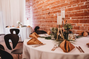 Modern Tropical Florida Wedding Reception and Decor, Round Tables with Gold Napkin Linens, Palm Leaf Greenery and Low Floral Centerpieces with Geometric Vase, Exposed Red Brick Wall | Unique Tampa Bay Wedding Venue NOVA 535