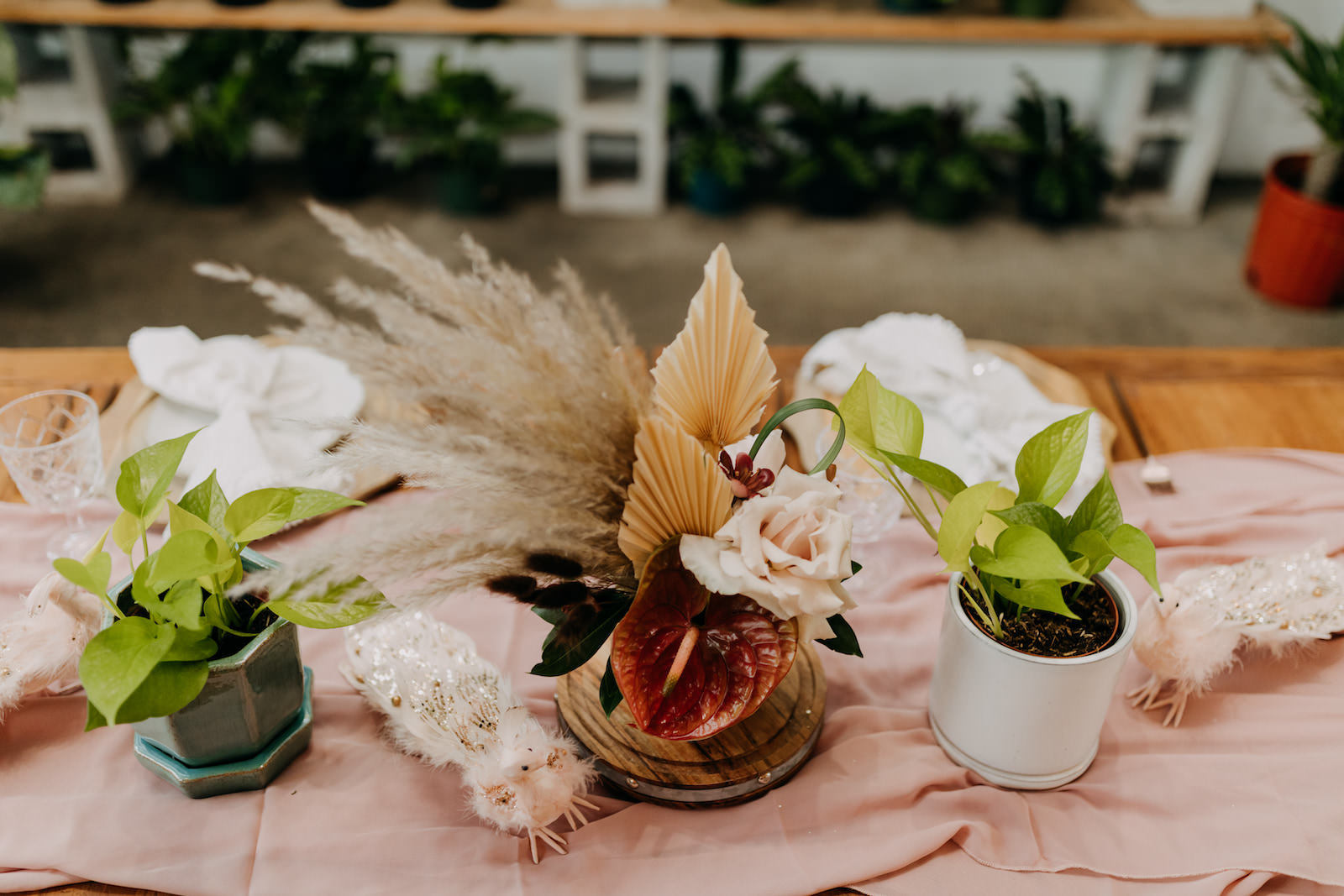 Boho Styled Shoot Decor | Unique Floral Centerpiece, Pampas Grass, Dried Flowers, Ivory Roses, Pink Anthurium, Greenery Plants, Blush Pink Table Runner, White Peacock Statue Decorations | Wedding Planner Elope Tampa Bay | Amber McWhorter Photography