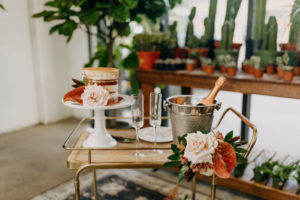 Boho Neutral Wedding Styled Shoot Decor | Vintage Gold Bar Cart with Unique Tropical Style Floral Bouquet with Palm Tree Leaves, Pink Anthurium, Ivory roses, Semi Naked Wedding Cake | Wedding Planner Elope Tampa Bay | Amber McWhorter Photography