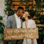 Boho Neutral Styled Shoot | Bride in Vintage Lace Fringe Short Sleeve V Neckline Wedding Dress Groom in Blue Plaid Suit with Greenery Plants | Unique St. Pete Wedding Venue Wild Roots Nursery | Amber McWhorter Photography | Wedding Planner Elope Tampa Bay