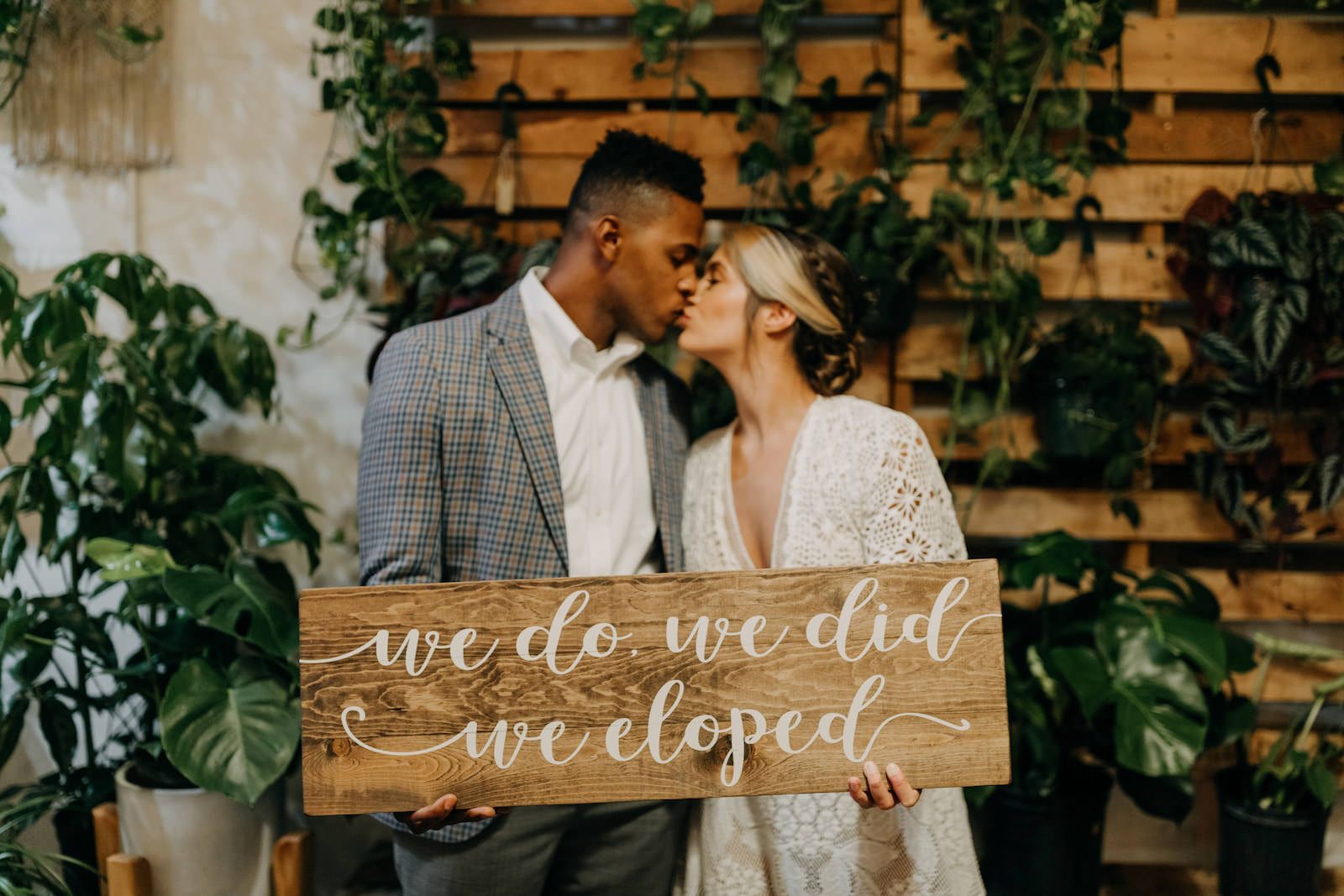 Boho Neutral Styled Shoot | Bride in Vintage Lace Fringe Short Sleeve V Neckline Wedding Dress Groom in Blue Plaid Suit with Greenery Plants | Unique St. Pete Wedding Venue Wild Roots Nursery | Amber McWhorter Photography | Wedding Planner Elope Tampa Bay