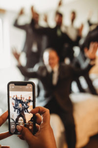 Fun Florida Groomsmen Photo, Guys on Bed with Photo View of Cell Phone