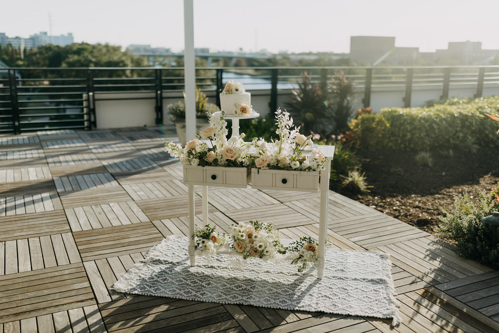 Neutral Modern Wedding Decor, White Dresser with White Floral Bouquets and Small One Tier Wedding Cake | Wedding Planner Elope Tampa Bay | Wedding Photographer Amber McWhorter | Wedding Venue Rooftop 220