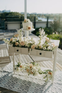 Neutral Modern Wedding Decor, White Dresser with White Floral Bouquets and Small One Tier Wedding Cake | Wedding Planner Elope Tampa Bay | Wedding Photographer Amber McWhorter | Wedding Venue Rooftop 220