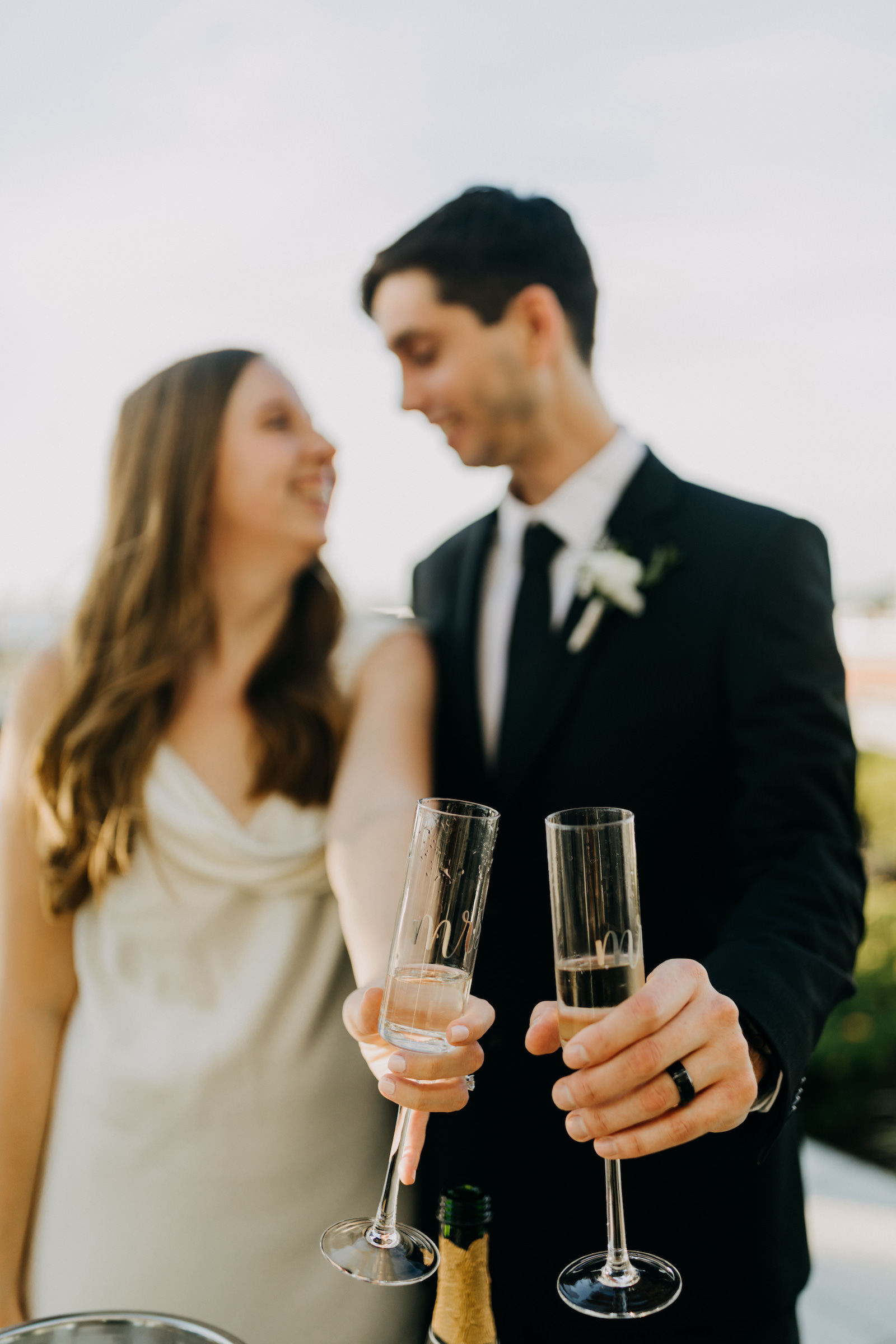 Bride and Groom Holding Champagne Flutes | Wedding Photographer Amber McWhorter | Wedding Planner Elope Tampa Bay