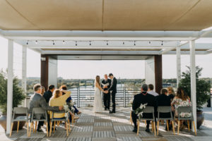 Modern Industrial Bride and Groom Exchanging Wedding Vows on Rooftop Ceremony | Tampa Wedding Venue Rooftop 220 | Wedding Planner Elope Tampa Bay | Wedding Photographer Amber McWhorter