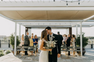 Modern Industrial Bride and Groom Wedding Ceremony Exit Photo | Tampa Bay Wedding Venue Rooftop 220 | Wedding Planner Elope Tampa Bay | Wedding Photographer Amber McWhorter