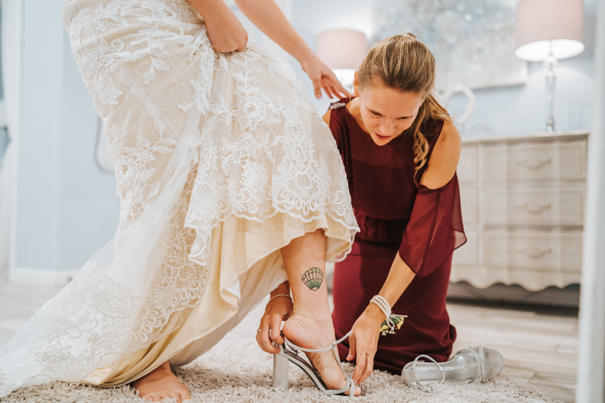 Bride Getting Dressed and Ready with Bridesmaid Putting on Shoes | Long Burgundy Chiffon Bridesmaid Dress | V Neck Champagne Lace Bridal Gown Wedding Dress
