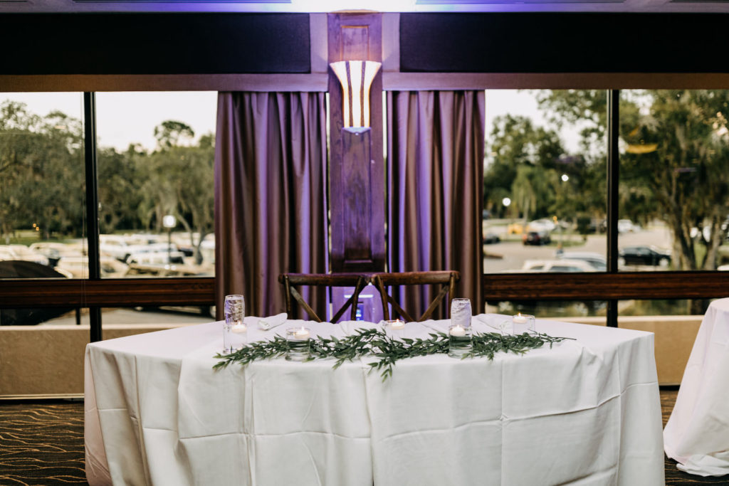 Classic Wedding Reception Decor, Purple Uplighting, Sweetheart Table with Greenery Garland, Wooden Chiavari Chairs | Tampa Bay Wedding Photographer Amber McWhorter Photography