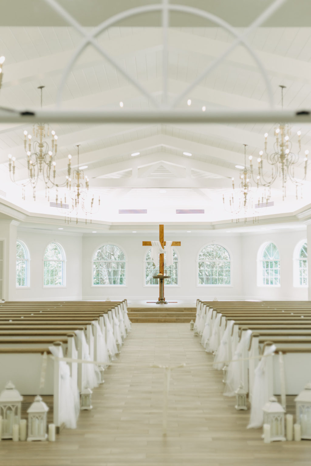 Traditional Wedding Ceremony Decor, White Lanterns with Candles, Wooden Cross at Altar | Safety Harbor Wedding Venue Harborside Chapel | Tampa Bay Wedding Photographer Amber McWhorter Photography