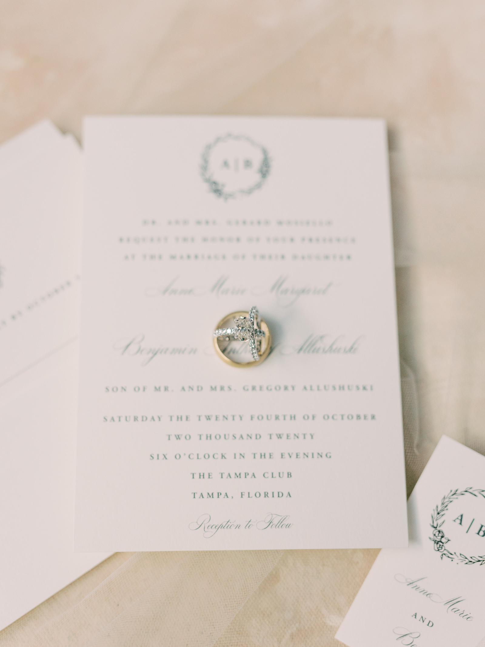 Traditional Tampa Wedding Invitation with Floral Halo Monogram in Dusty Blue Ink with Calligraphy | Wedding Ring Shot With Stationary | Oval Diamond Tiffany Solitaire Engagement Ring with Channel Set Diamond Band