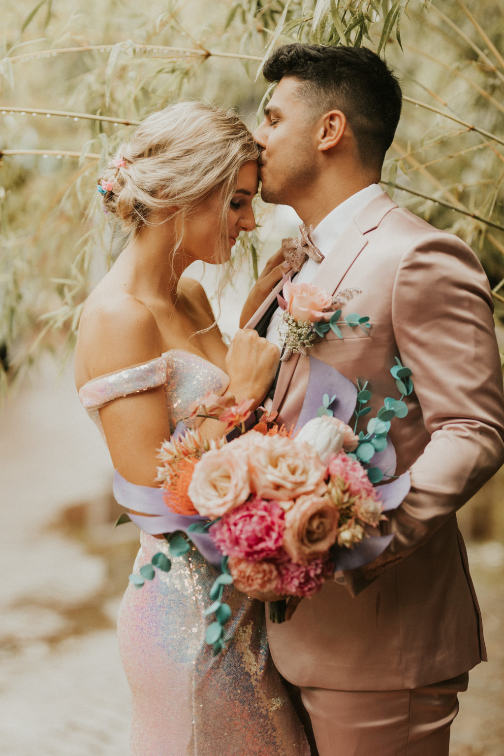 Iridescent Pastel 90's Wedding Inspiration | Pastel Rose and Orchid Bouquet with Painted Monstera and Eucalyptus Leaves | Bride and Groom Portrait with Blush Pink Suit and Shimmer Silver Wedding Dress