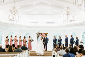 Indoor Church Wedding Ceremony at Safety Harbor Wedding Venue Harborside Chapel | Blush Pink Dusty Rose Mauve Bridesmaid Dresses | Groomsmen Navy Suits