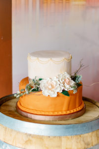 Modern Boho Two Tier White and Orange Wedding Cake with Sugar Flowers