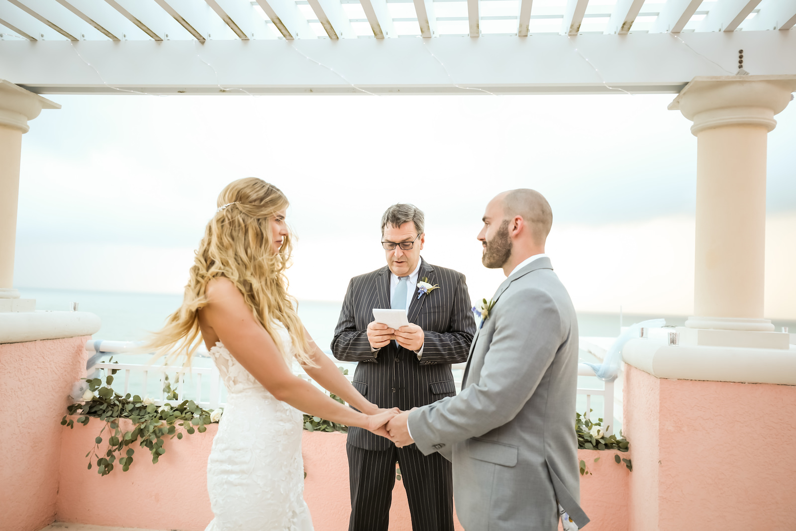 Outdoor Wedding Terrace Ceremony at Clearwater Wedding Venue Hyatt Regency Clearwater Beach | Groom Wearing Silver Grey Suit | Strapless Lace Sweetheart Mermaid Wedding Dress Bridal Gown