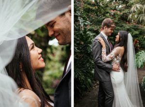 Tropical Elegant Inspired Florida Bride and Groom at Sunken Gardens in St. Petersburg, Bride Wearing White BHLDN Wedding Dress with Long Illusion Lace Sleeves and Flowy Veil | Tampa Bay Wedding Planner John Campbell Weddings