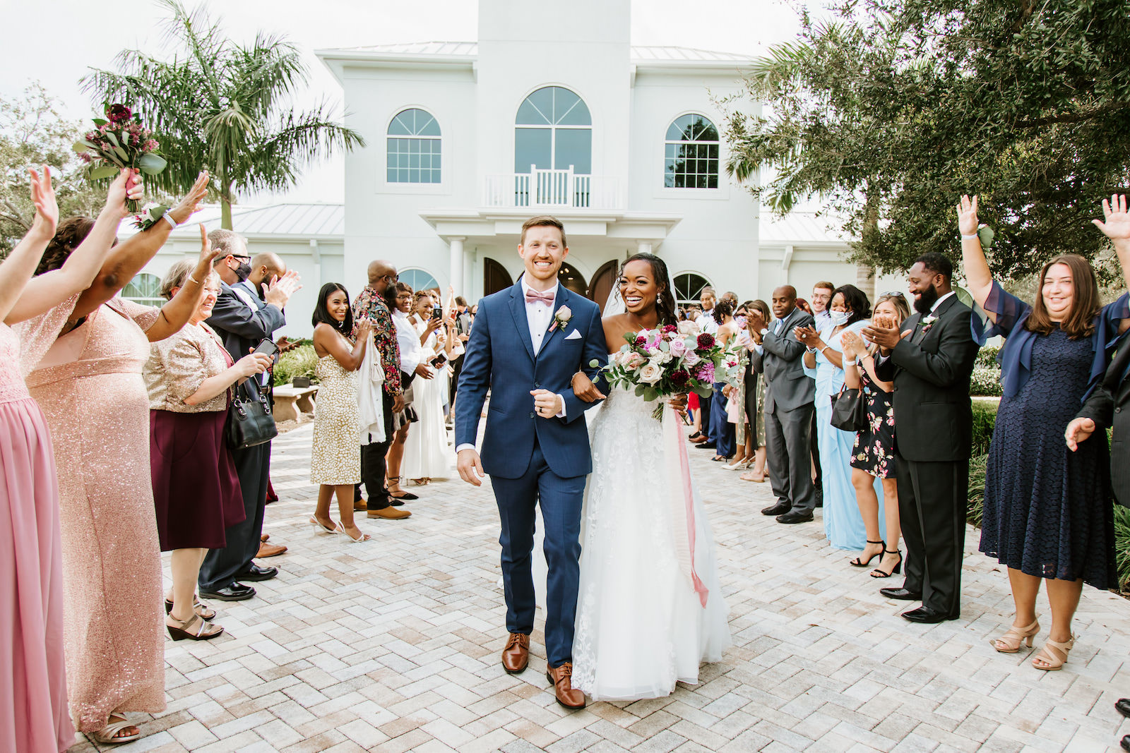 Church Wedding Bride and Groom Exit at St. Pete Wedding Venue Harborside Chapel | Groom in Navy Suit | Tulle and Lace Ballgown Wedding Dress