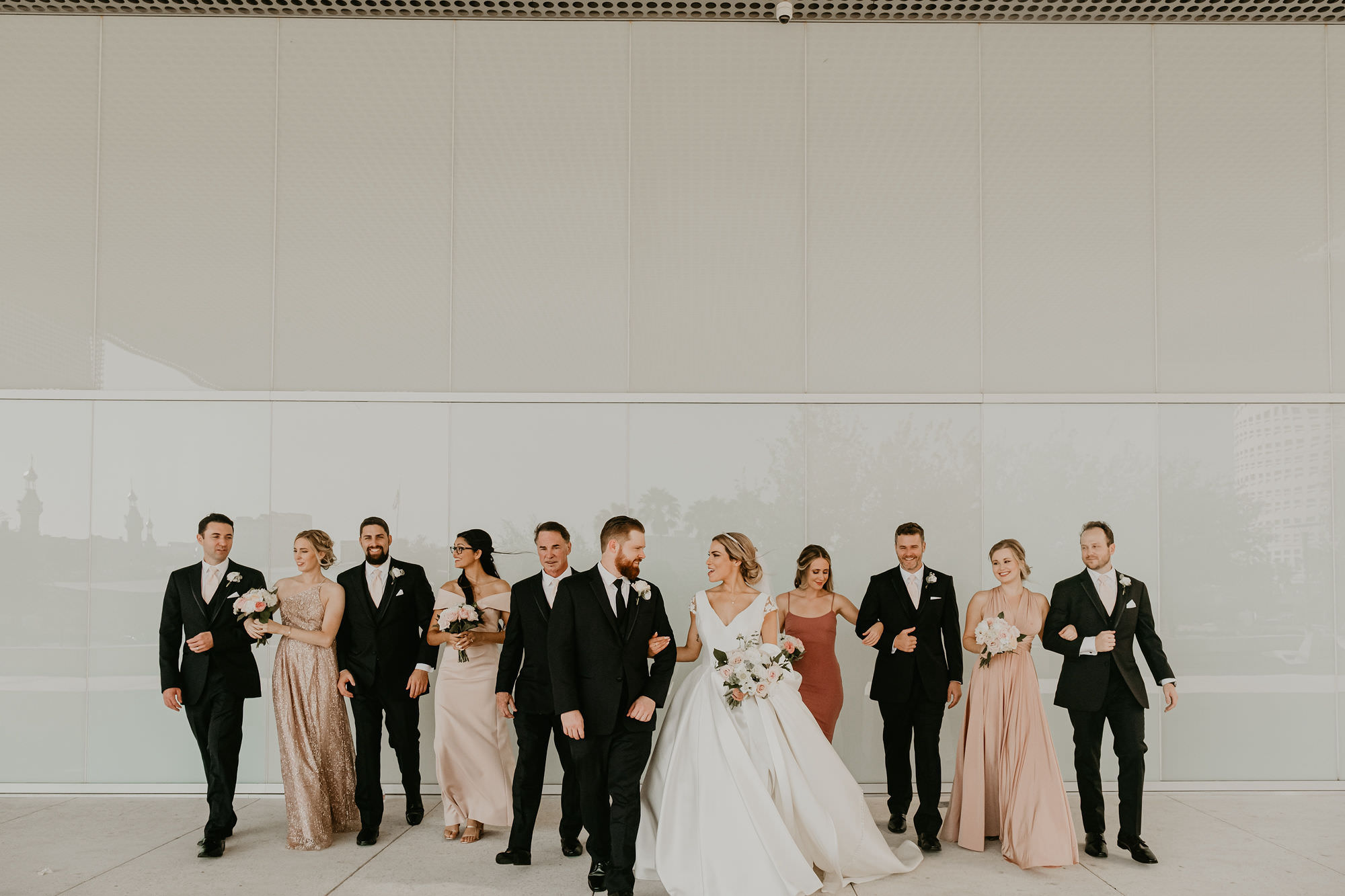 Outdoor Wedding Party Portrait | Nude Pink Blush Champagne Mismatch Bridesmaid Dresses | Neutral Wedding Bouquets with White and Ivory and Blush Champagne Roses | Low Back Ballgown Wedding Dress by Anomalie | Groom and Groomsmen in Classic Black Suit Tux