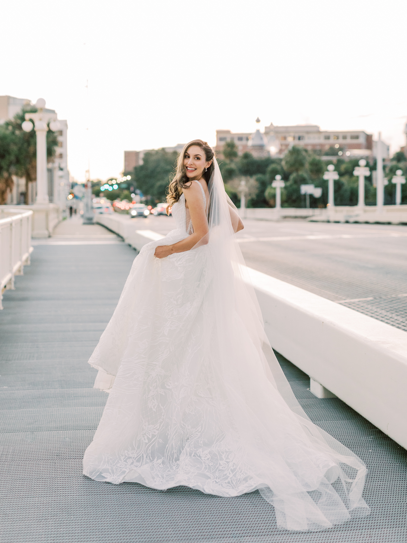 Urban Outdoor Bridal Portrait in Streets of Downtown Tampa | V Back Embroidered Illusion Panel Allure Couture Designer Wedding Dress Bridal Gown with Long Cathedral Veil