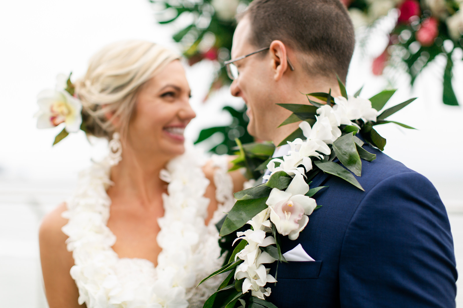Tropical Elegant Bride and Groom Wearing Floral Leighs with White Flowers and Green Palm Tree Leaves