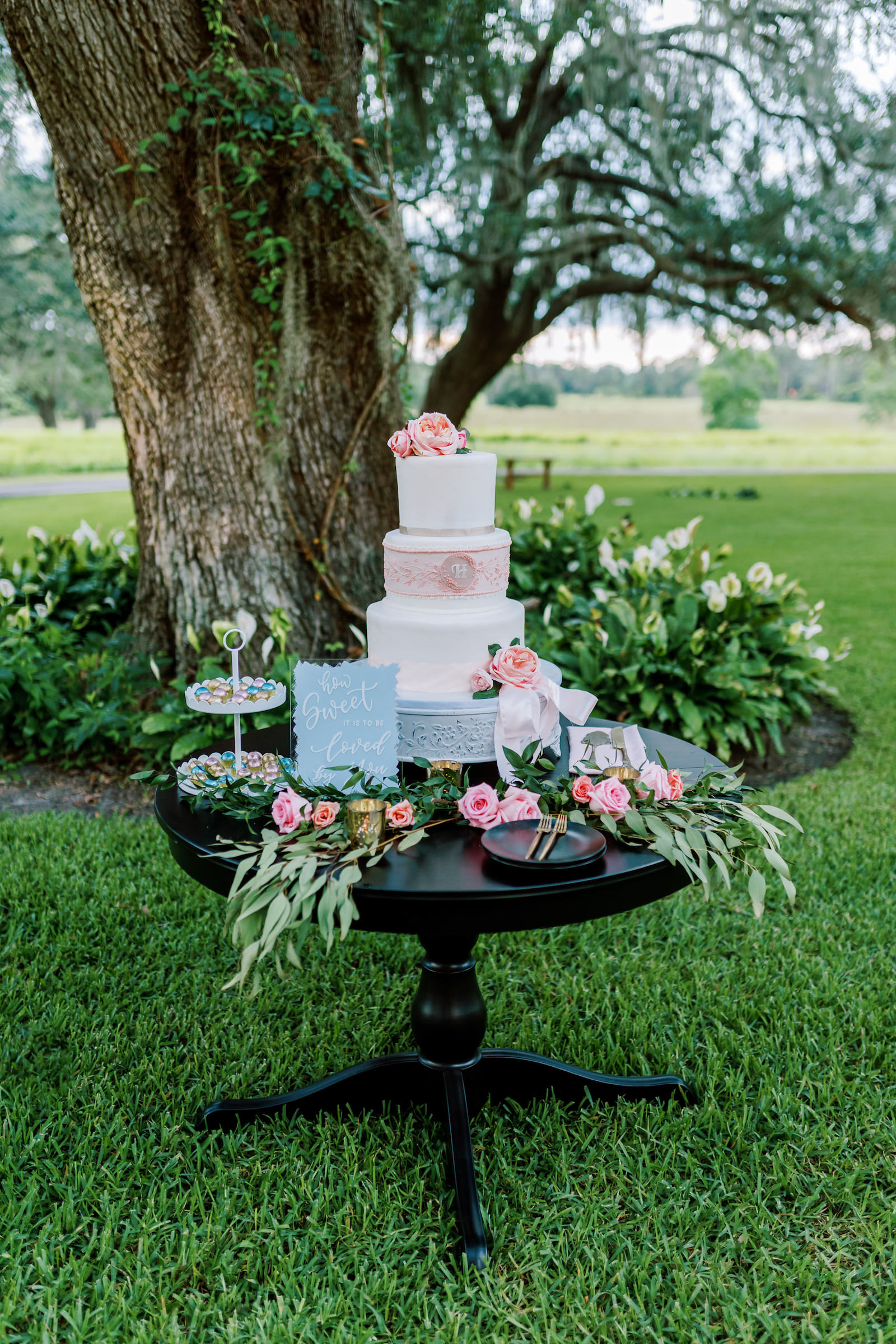 Outdoor Florida Wedding Reception Cake Table with Floral Garland