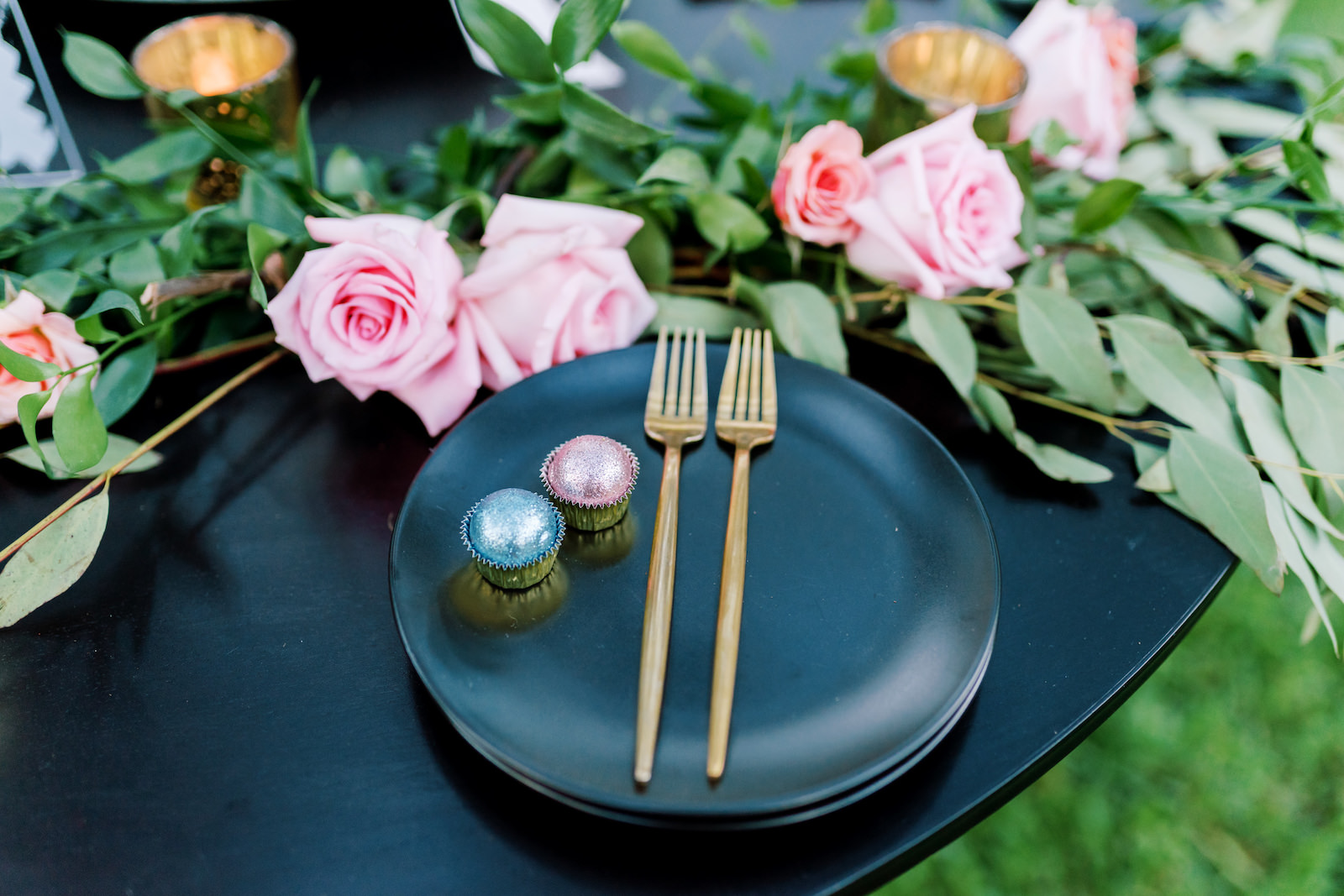 Romantic, Vintage Inspired Florida Wedding Table Setting, Dark Blue Plates with Gold Flatware and Pink and Blue custom Candies, Magnolia Leaves for Greenery with Roses | Tampa Bay Wedding Planners EventFull Weddings