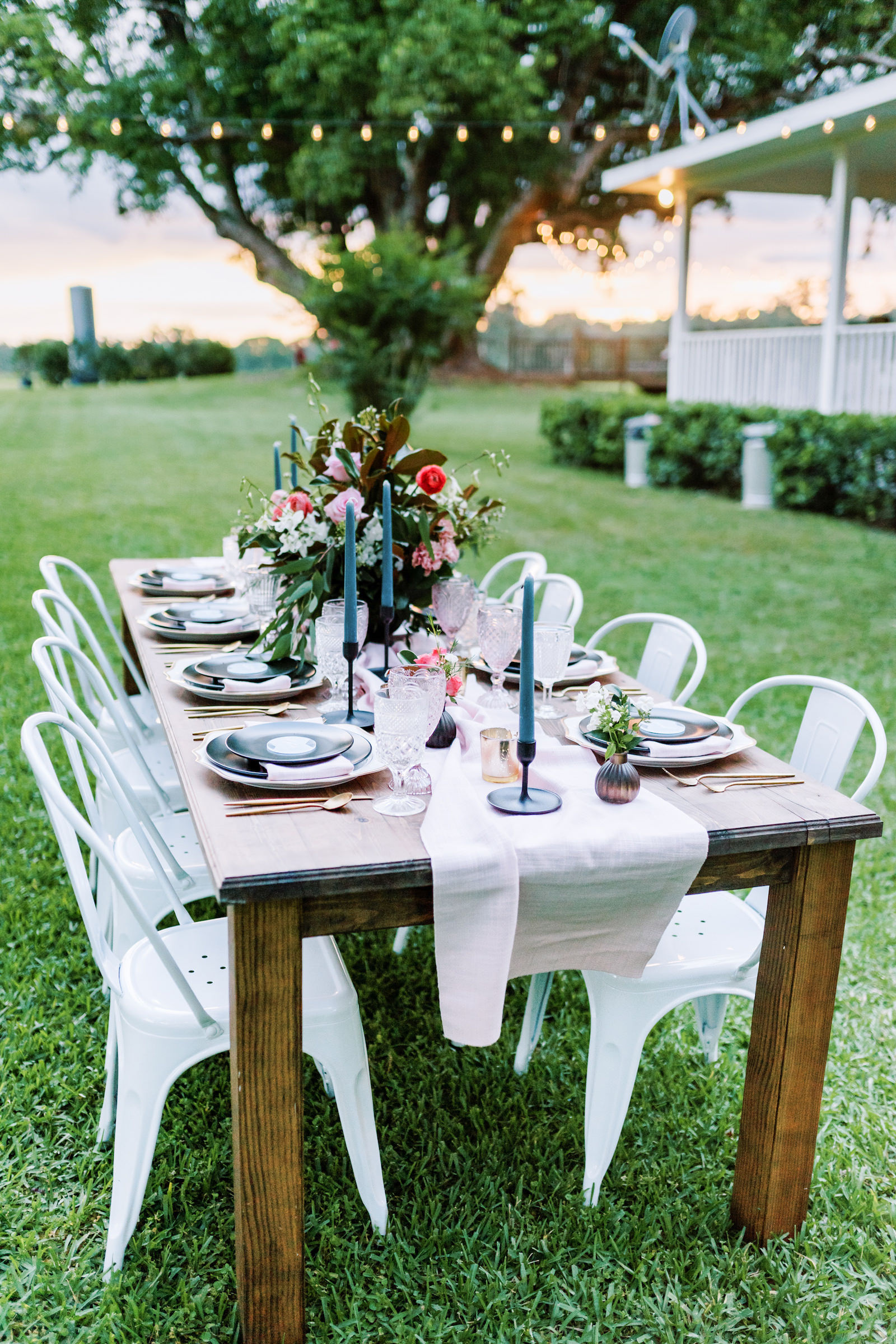 Southern Elegant Inspired Florida Outdoor Wedding Reception, Wood Table with Dark Blue Place Setting, Gold Flatware, Pink Burlap Linens, Multicolored Glass Goblets, Floral Centerpiece with Magnolia Leaves | Tampa Bay Wedding Planner EventFull Weddings | Florida Wedding Rentals Over The Top Linens | Two Sisters Ranch Dade City Florida