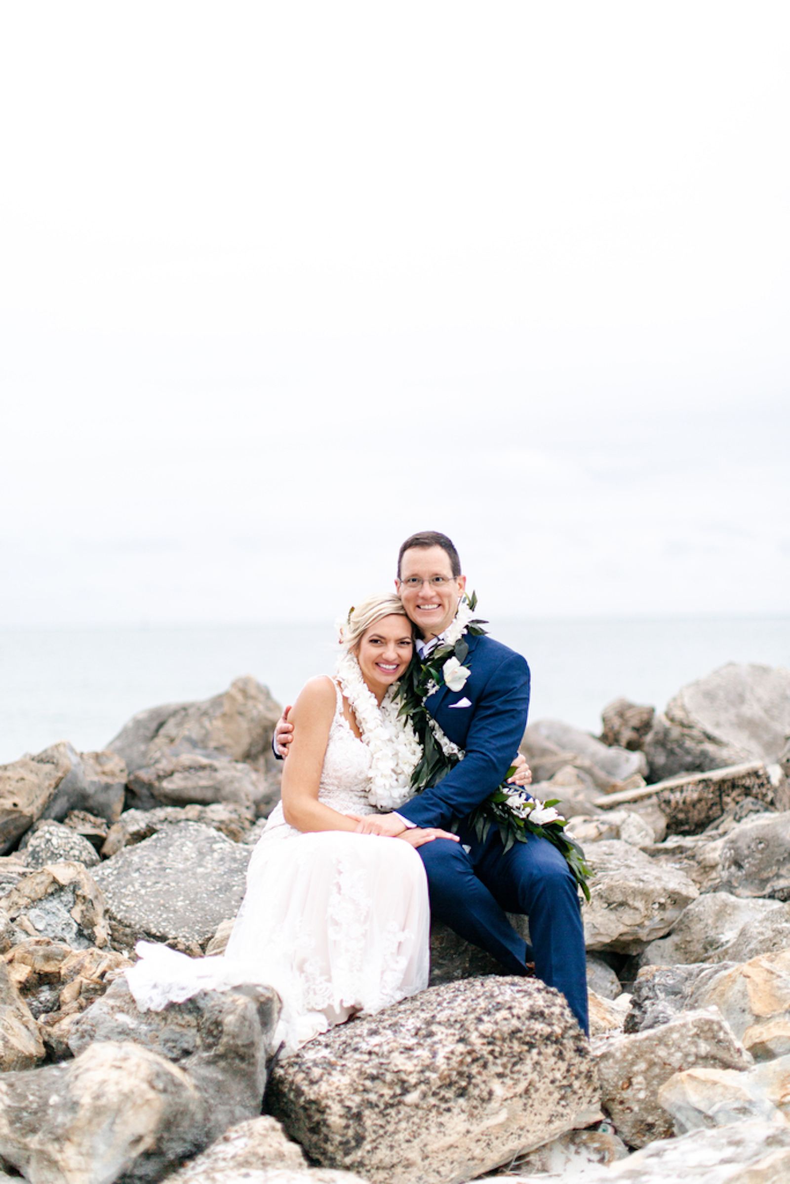 Tropical Clearwater Beach Bride and Groom Sitting on Rocks