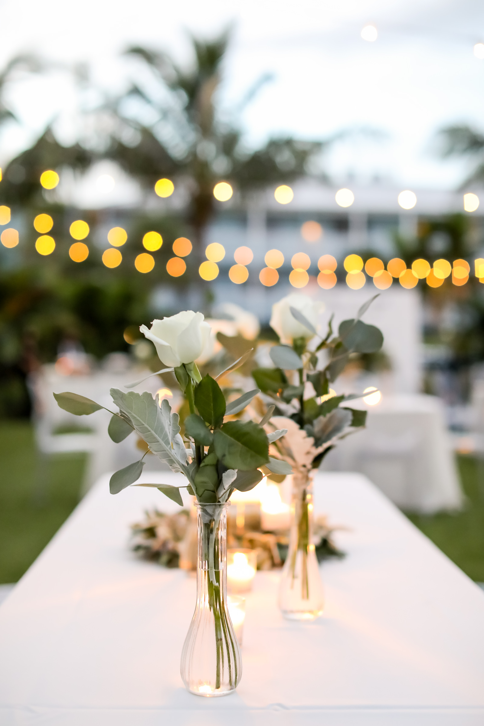 Vintage Inspired Florida Wedding Ceremony and Decor, Low Floral Centerpieces with Clear Glass Votives and Single Ivory Roses with Greenery, Candlelight | Sarasota Wedding Planner Kelly Kennedy Weddings | Florida Wedding Photographer Lifelong Photography Studio