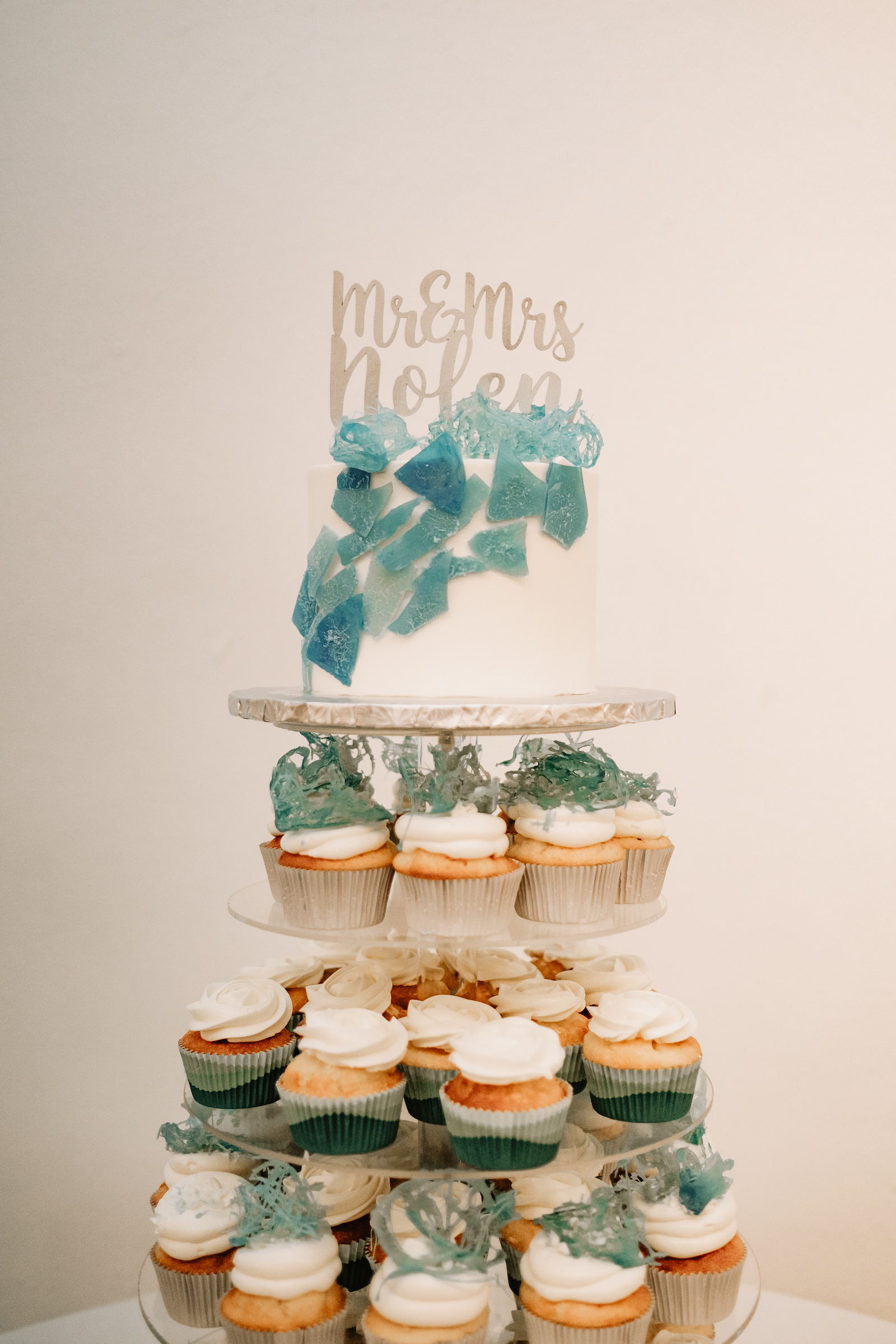 Coastal Clearwater Beach Wedding Cake Cupcake Tower with Sugar Sea Glass and Die Cut Name Cake Topper | The Artistic Whisk