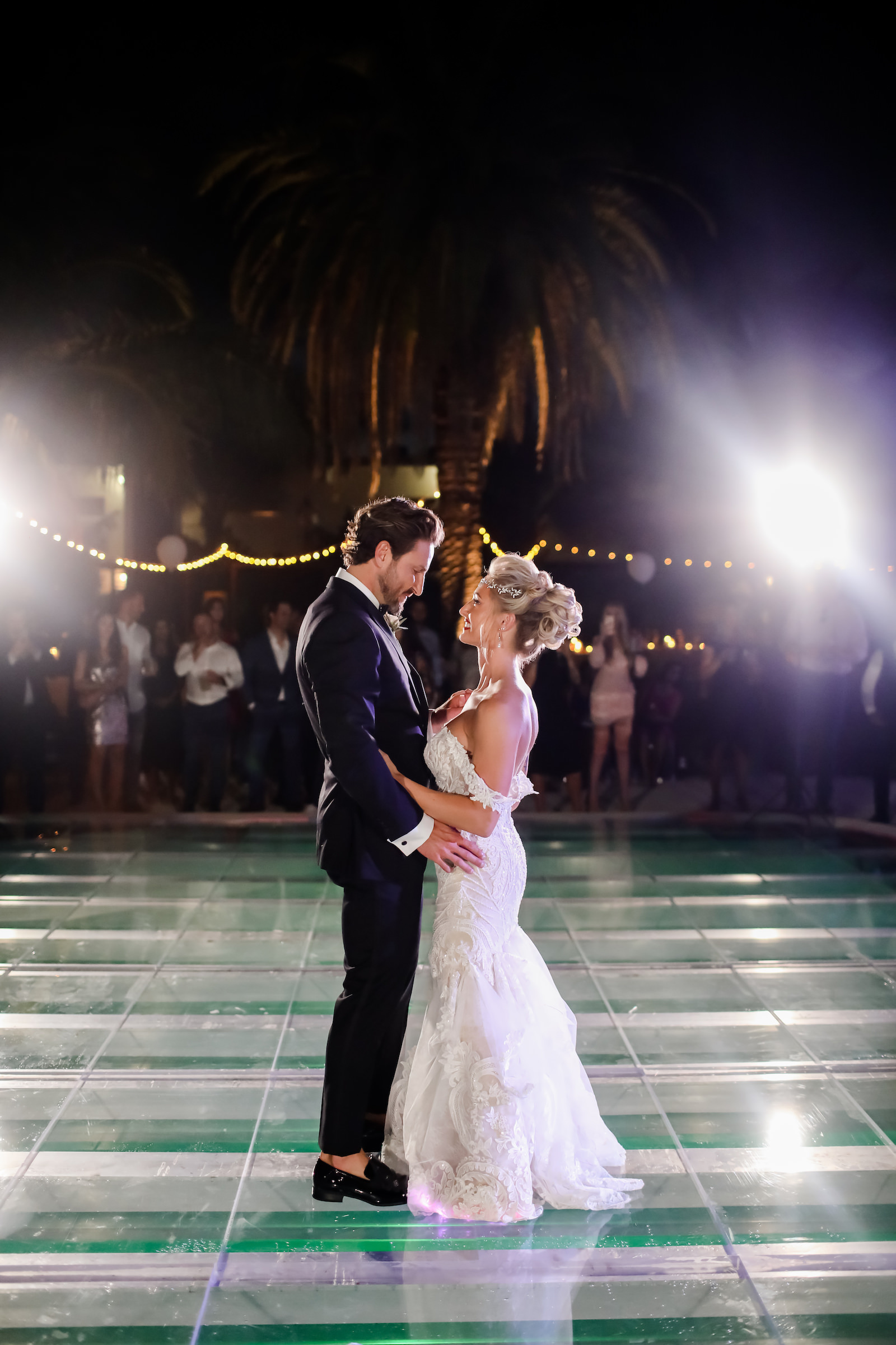 Tropical Inspired Wedding Reception with Bride and Groom Dancing on Acrylic Floor Covering Pool | Sarasota Wedding Planner Kelly Kennedy Weddings | Florida Wedding Photographer Lifelong Photography Studios