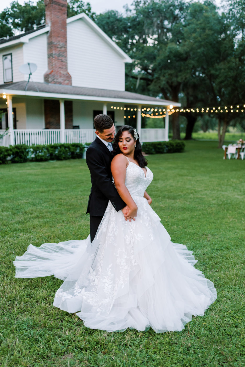 Tampa Bay Bride and Groom at Two Sisters Ranch in Dade City Wedding, Bride in Ballgown Style White Dress with V Neckline and Vintage Inspired Hair and Makeup with Hollywood Curls | Florida Wedding Planner EventFull Weddings