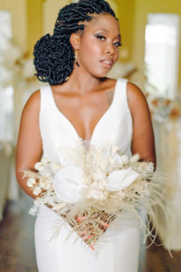 Bride in Classic V Neck Fitted Wedding Dress Holding White Preserved Flowers and Foliage, Feathers, Floral Bouquet | Tampa Bay Wedding Planner, Florist and Designer John Campbell Weddings | Wedding Hair and Makeup Michele Renee the Studio