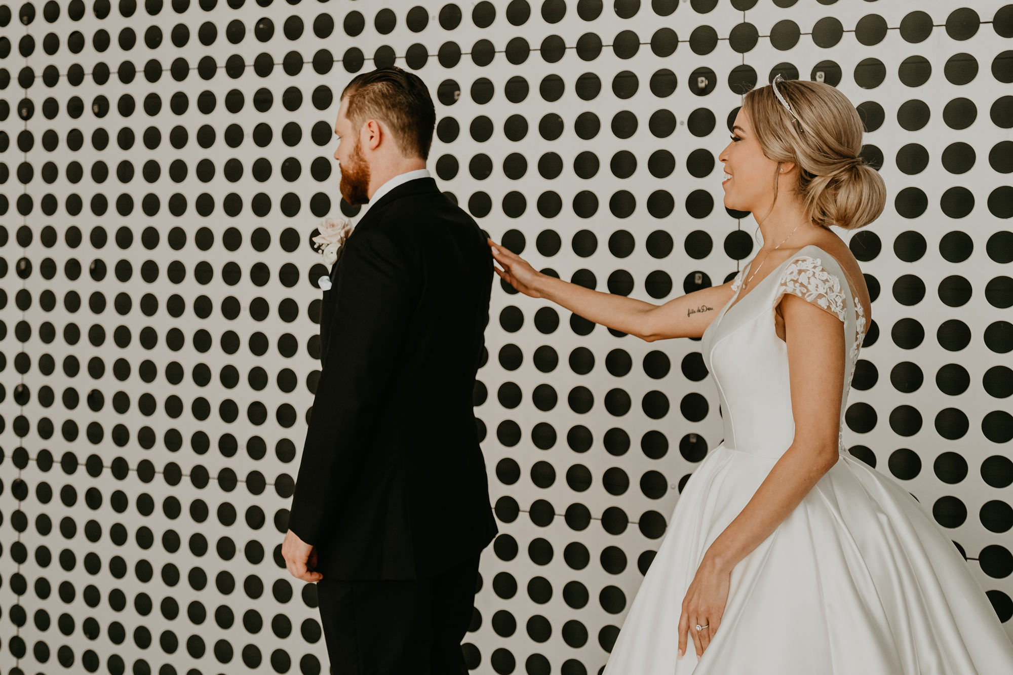 Bride and Groom First Look | Groom in Classic Black Suit Tux | Low Back Ballgown Wedding Dress by Anomalie